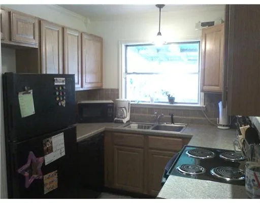 a kitchen with a sink stove and microwave