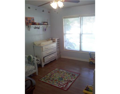 1509 Austin Street Portland, TX 78374 - Photo 5 of 10 a room with a bed and a chandelier