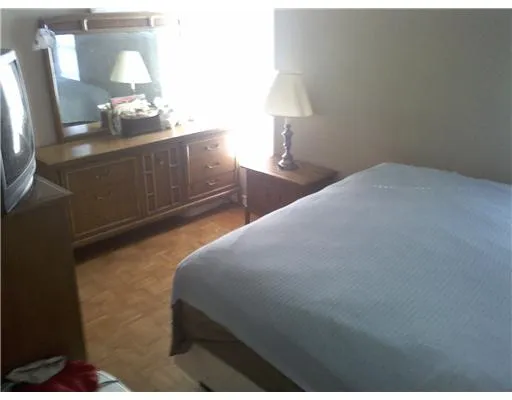 a bedroom with a bed and a lamp on table