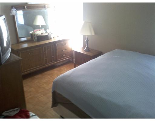 1509 Austin Street Portland, TX 78374 - Photo 8 of 10 a bedroom with a bed and a lamp on table