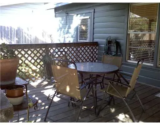 a backyard of a house with table and chairs
