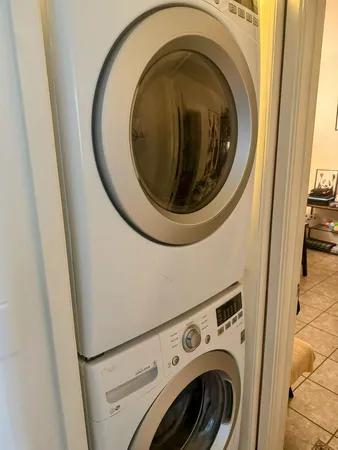 a utility room with stainless steel appliances a sink and a stove