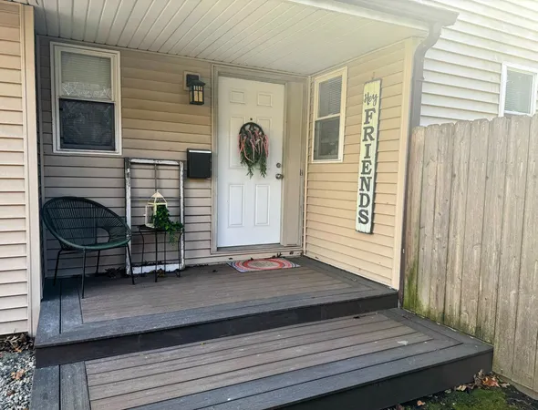 a view of a house with a door and wooden floor