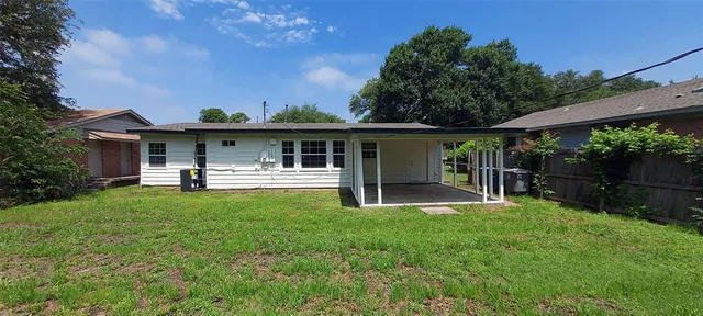 a front view of a house with a yard table and chairs