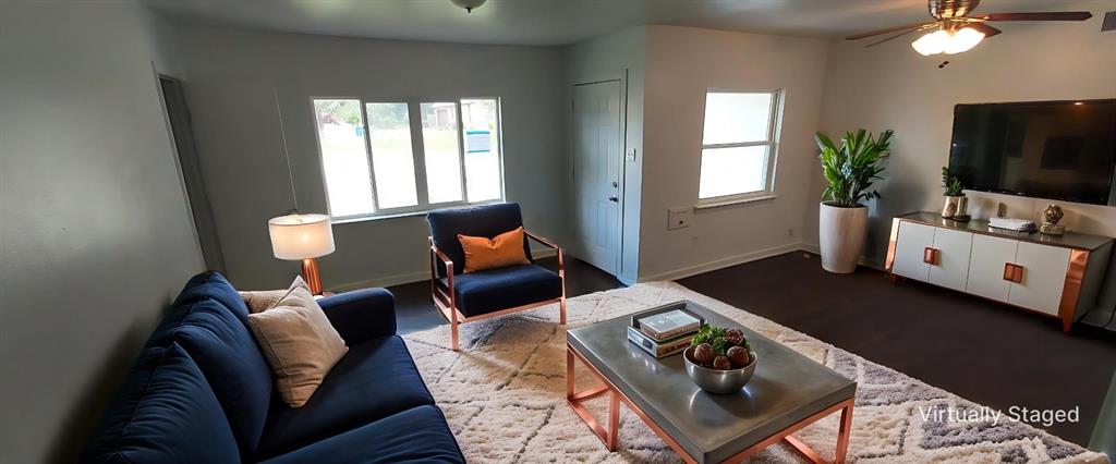 12202 Bellafonte Drive Dallas, TX 75243 - Photo 2 of 14 a living room with furniture and a flat screen tv
