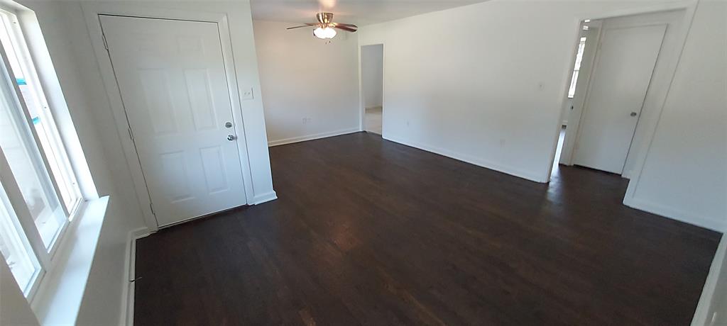 12202 Bellafonte Drive Dallas, TX 75243 - Photo 3 of 14 an empty room with wooden floor and windows