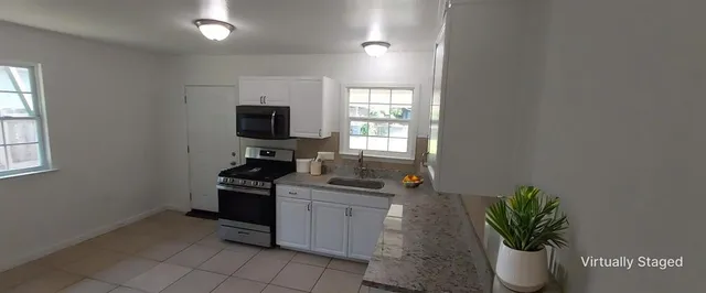 a kitchen with a sink and a stove top oven