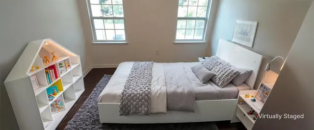 a bed sitting in a bedroom next to a window