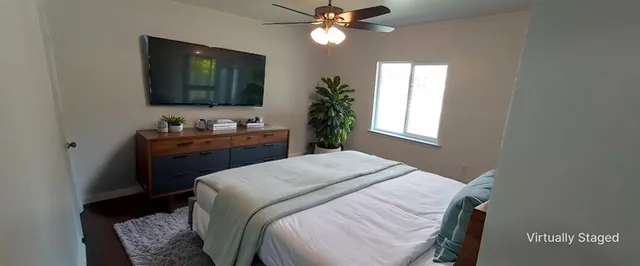a bedroom with a bed and a flat screen tv