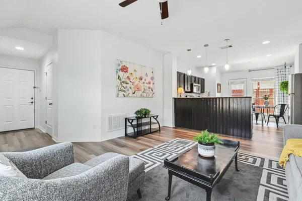 a living room with furniture and wooden floor