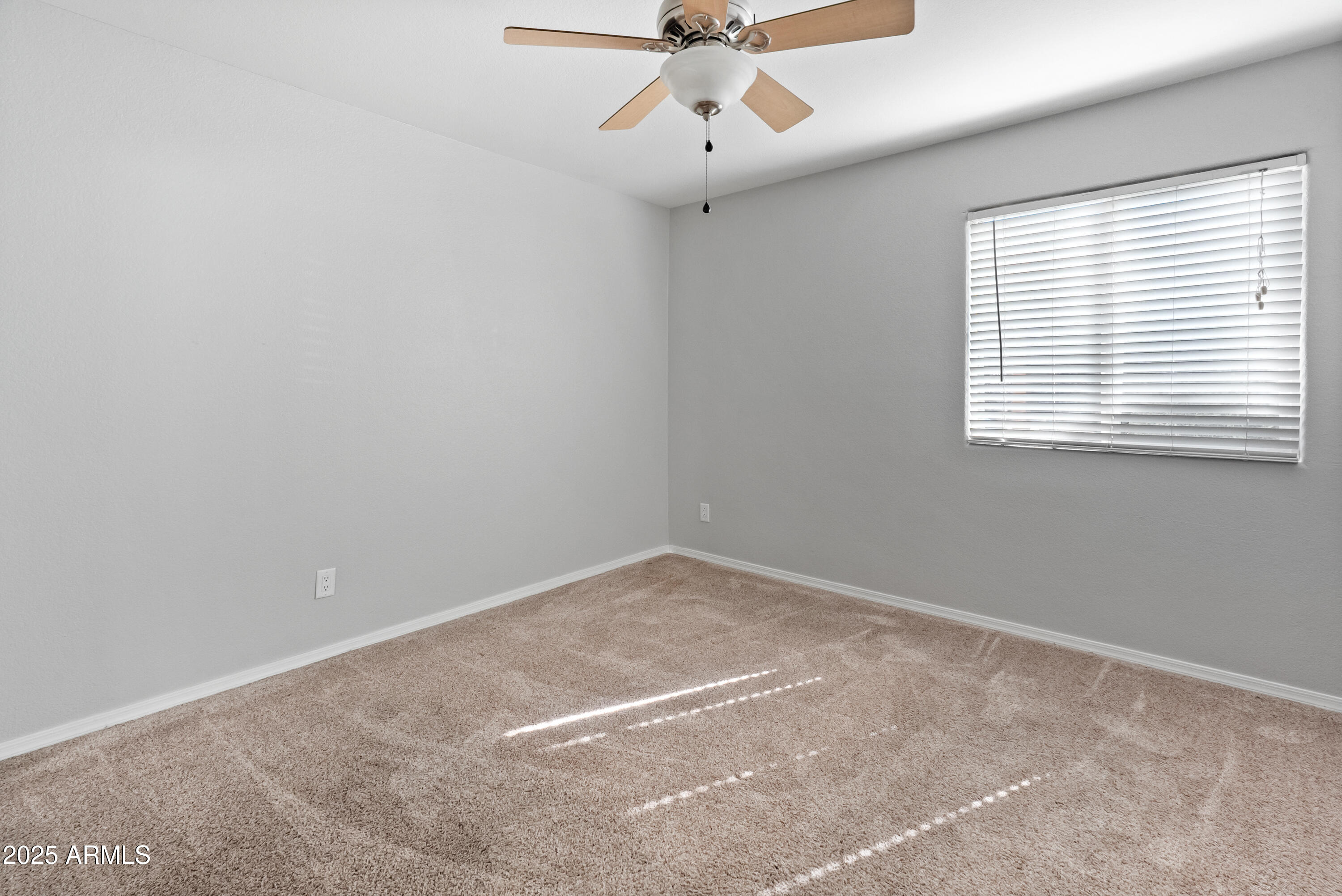 2121 West Royal Palm Road, Unit 1013 Phoenix, AZ 85021 - Photo 13 of 20 an empty room with a window and a fan