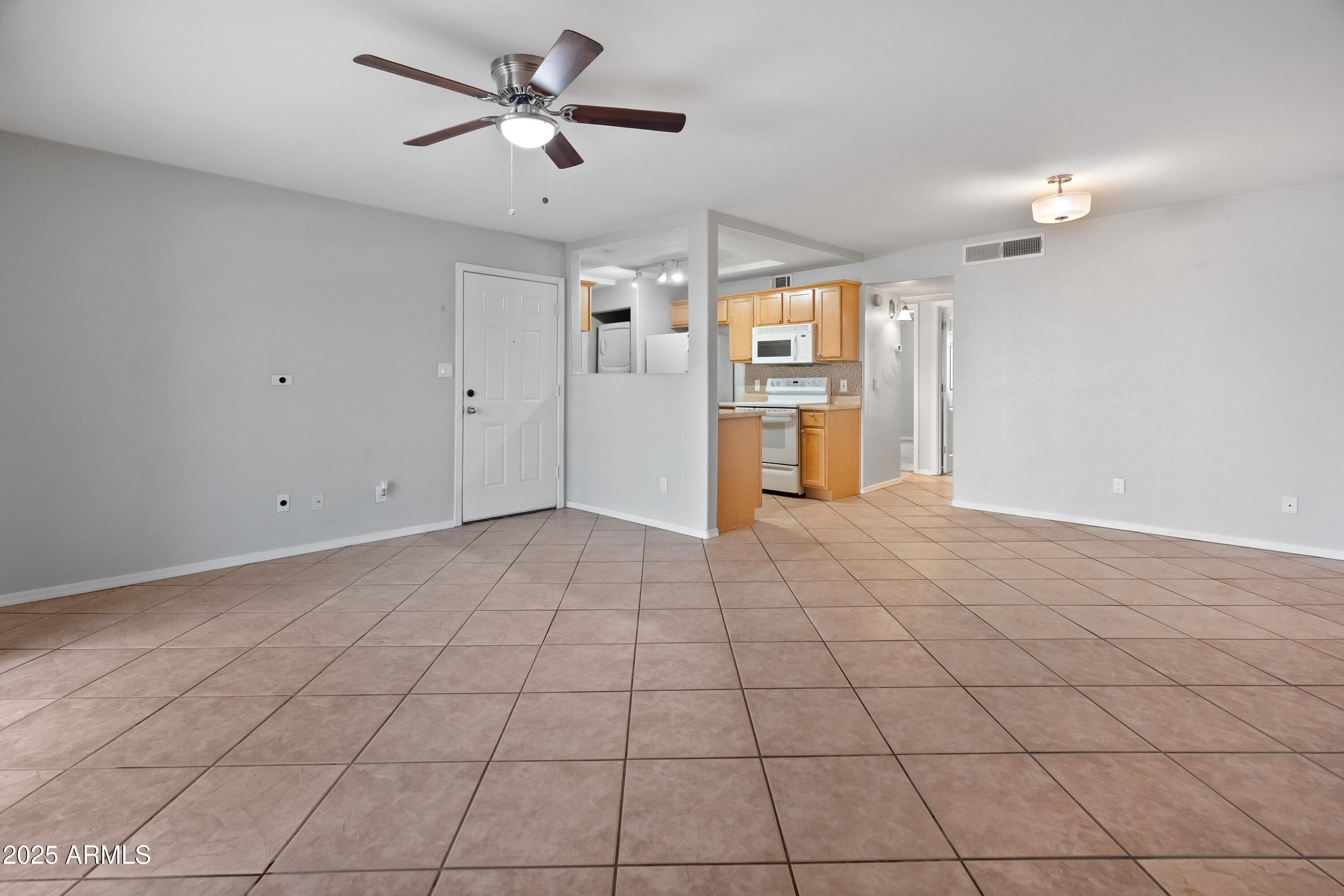 2121 West Royal Palm Road, Unit 1013 Phoenix, AZ 85021 - Photo 5 of 20 a view of a livingroom with a ceiling fan and window