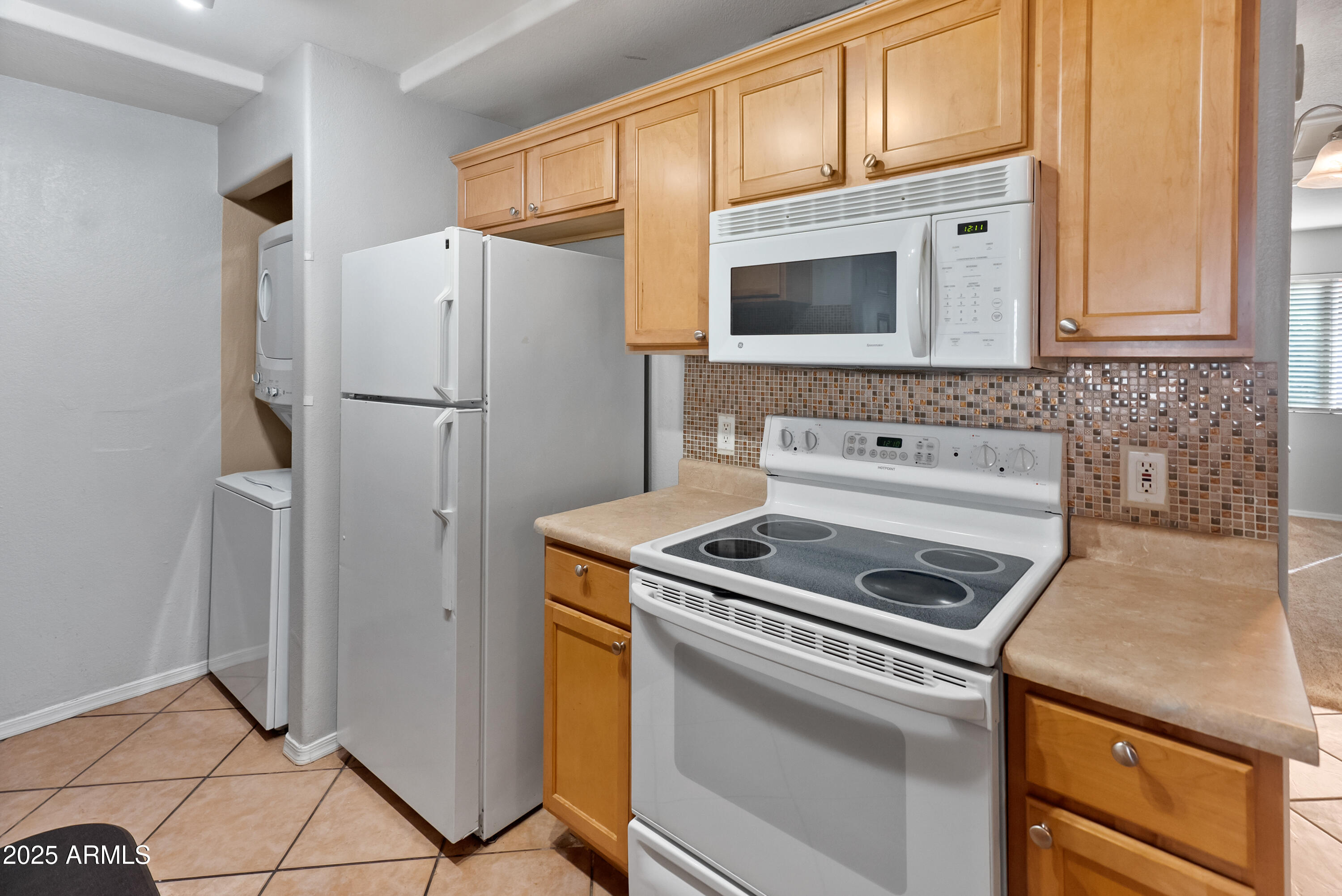 2121 West Royal Palm Road, Unit 1013 Phoenix, AZ 85021 - Photo 9 of 20 a kitchen with stainless steel appliances granite countertop a refrigerator sink and stove