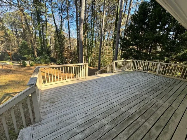 a view of a balcony with wooden floor and fence
