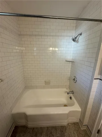 a bathroom with a bathtub and shower