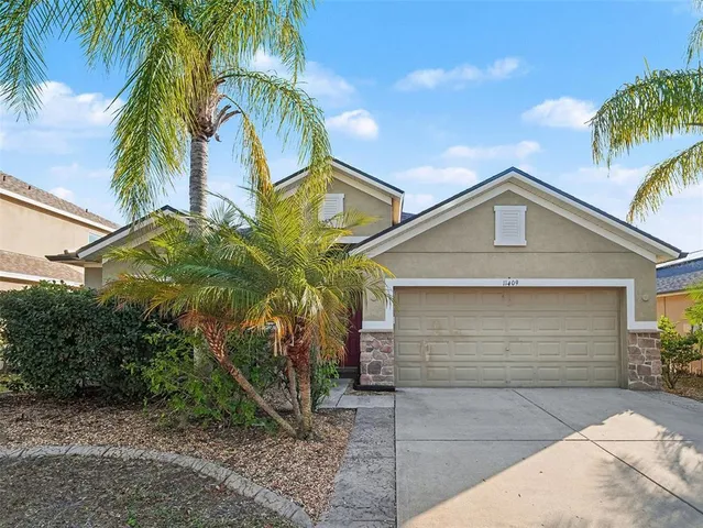 a view of a house with a palm tree
