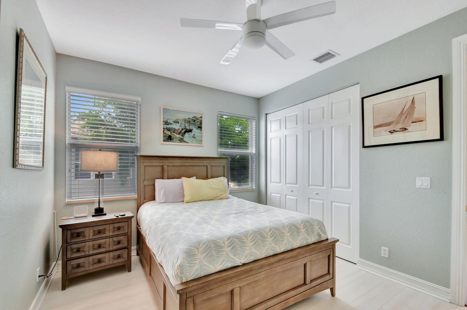 8679 Cobblestone Point Circle Boynton Beach, FL 33472 - Photo 15 of 31 a bedroom with a bed and a painting on the wall