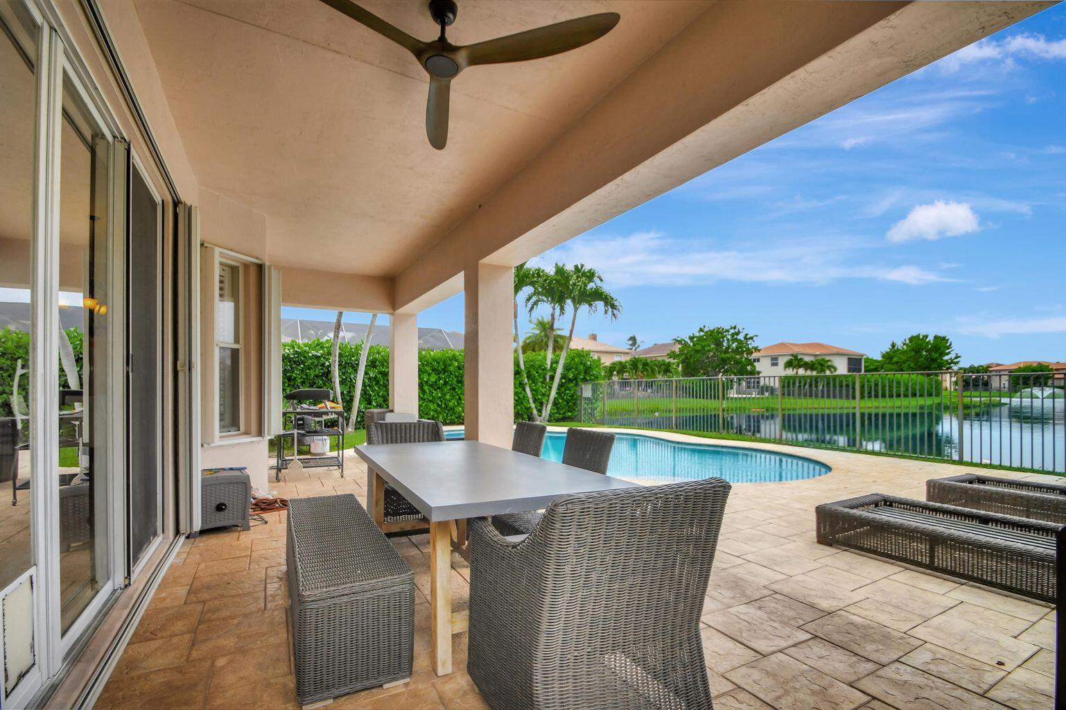 8679 Cobblestone Point Circle Boynton Beach, FL 33472 - Photo 2 of 31 a view of swimming pool with outdoor seating and plants