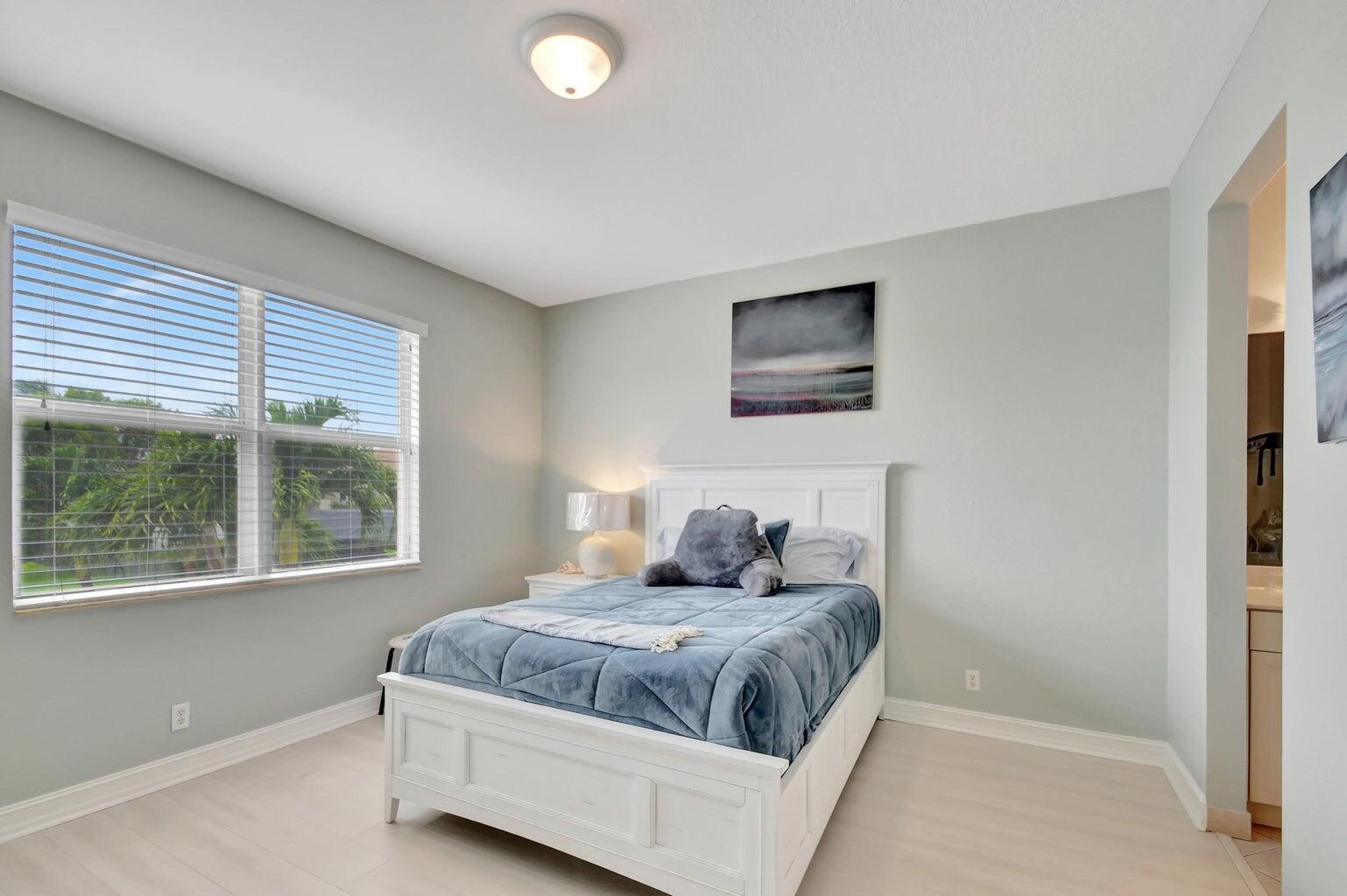 8679 Cobblestone Point Circle Boynton Beach, FL 33472 - Photo 21 of 31 a bedroom with a large bed and a window