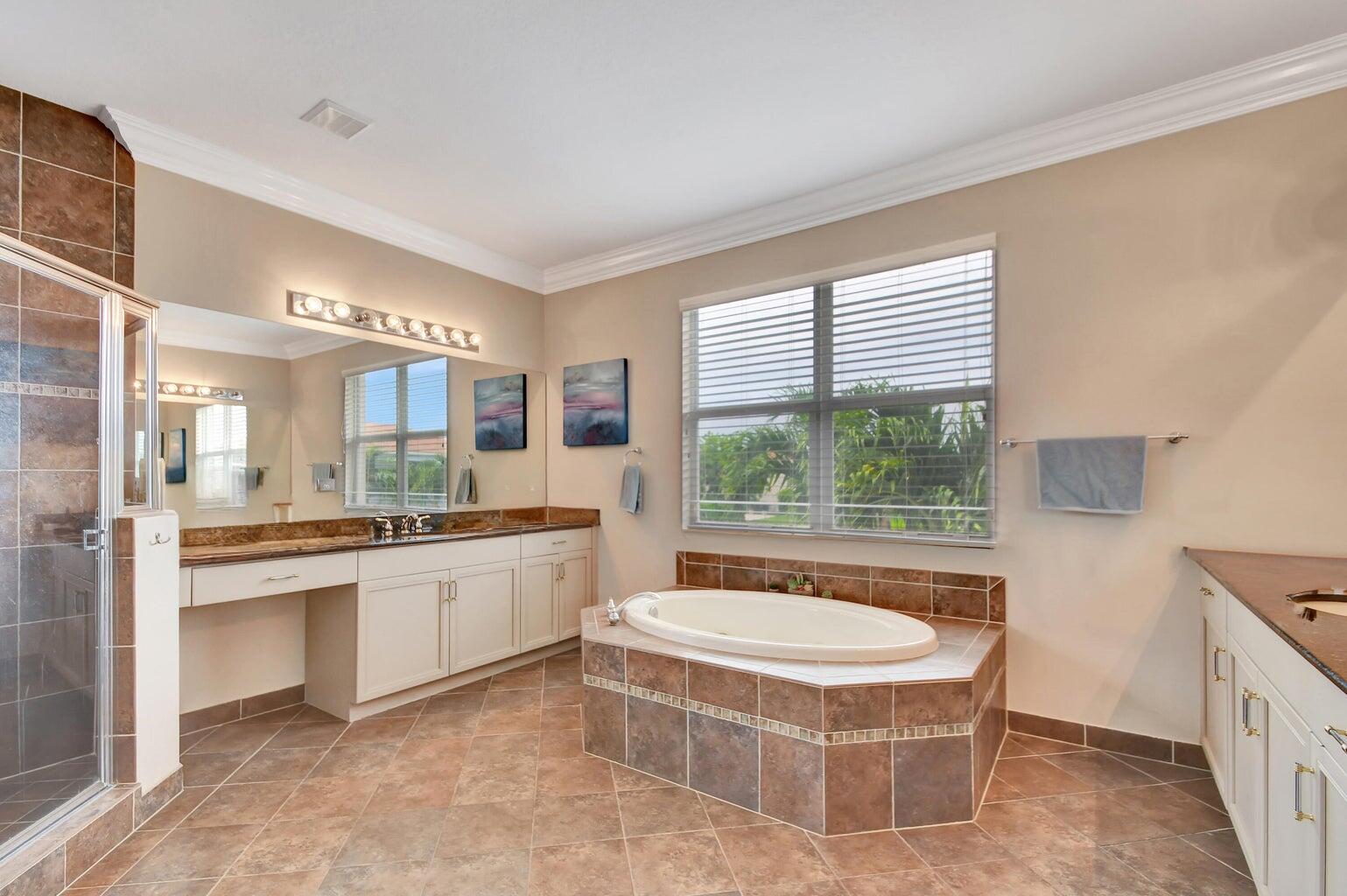 8679 Cobblestone Point Circle Boynton Beach, FL 33472 - Photo 23 of 31 a spacious bathroom with a tub sink and mirror