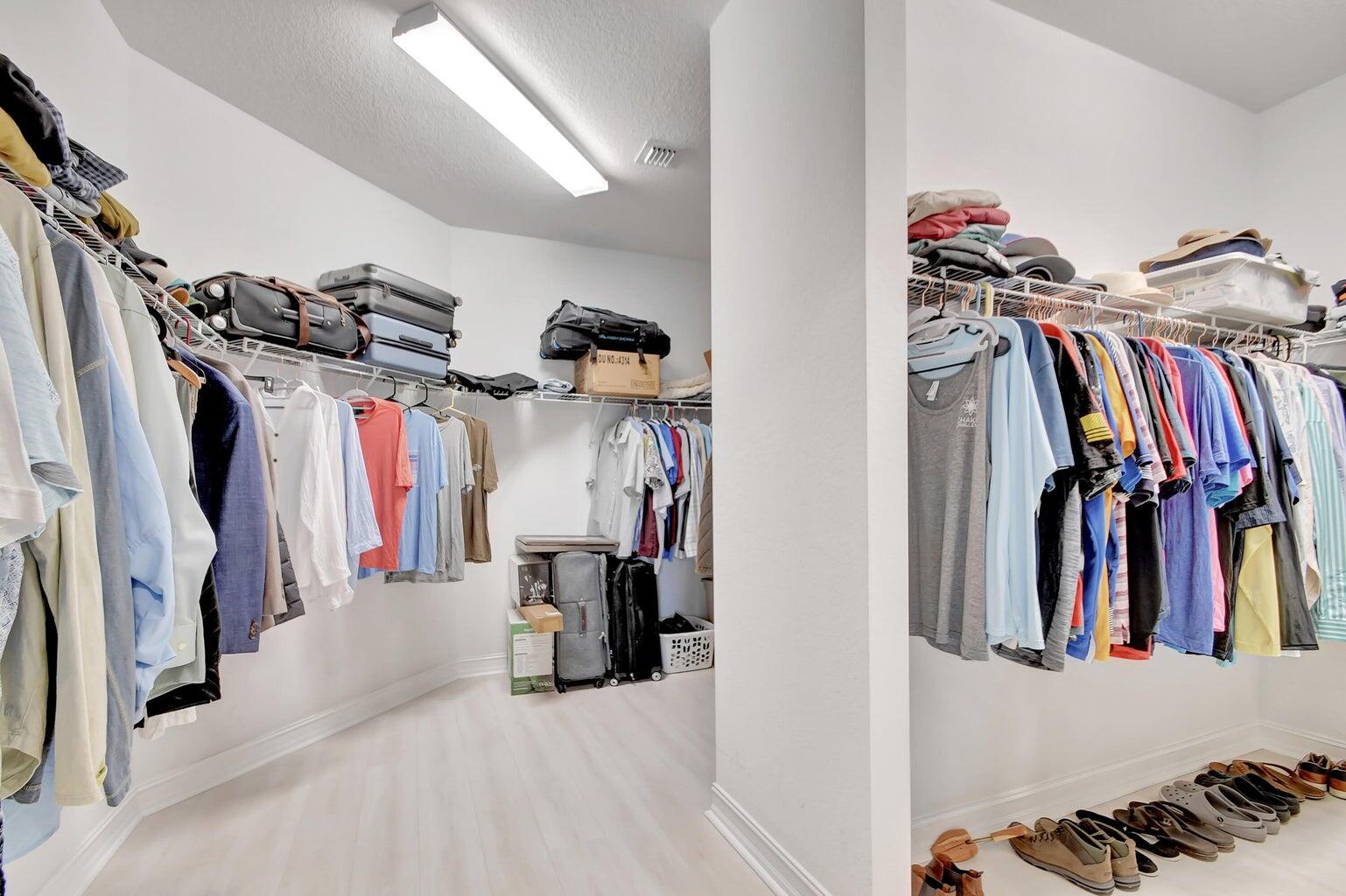 8679 Cobblestone Point Circle Boynton Beach, FL 33472 - Photo 25 of 31 a view of walk in closet with clothes and shoes