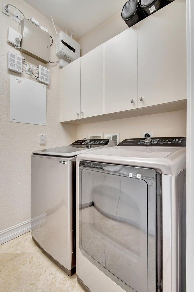 8679 Cobblestone Point Circle Boynton Beach, FL 33472 - Photo 26 of 31 a utility room with cabinets washer and dryer