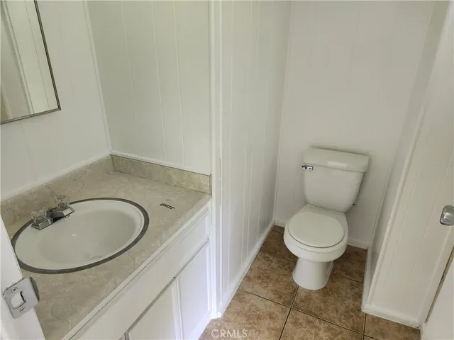 a bathroom with a sink toilet and a mirror