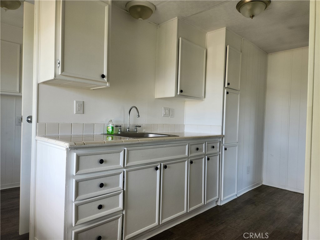 356 Chinese Wall Road Oroville, CA 95966 - Photo 23 of 30 a kitchen with granite countertop white cabinets and sink