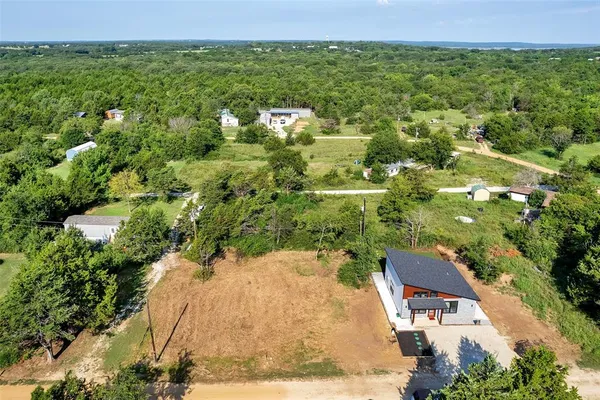 an aerial view of a house with a yard