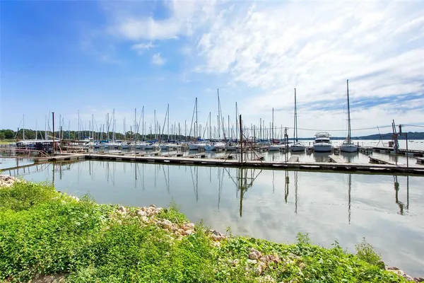 a view of a lake with boats and trees in the background