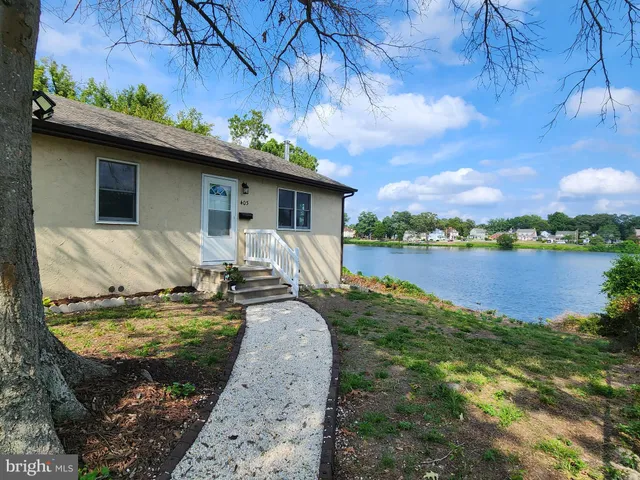 a view of a backyard with plants and lake view