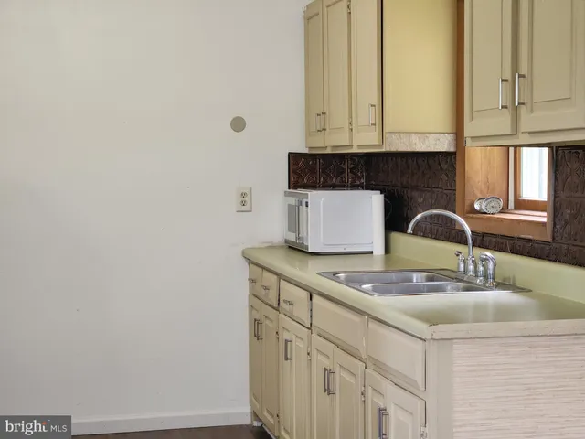 a kitchen with a white cabinets and sink