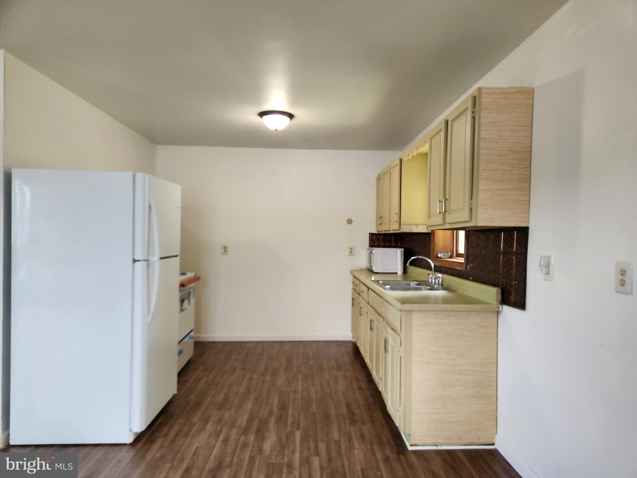 403 Rose Street Salisbury, MD 21801 - Photo 20 of 35 a kitchen with a sink a stove top oven and wooden floor