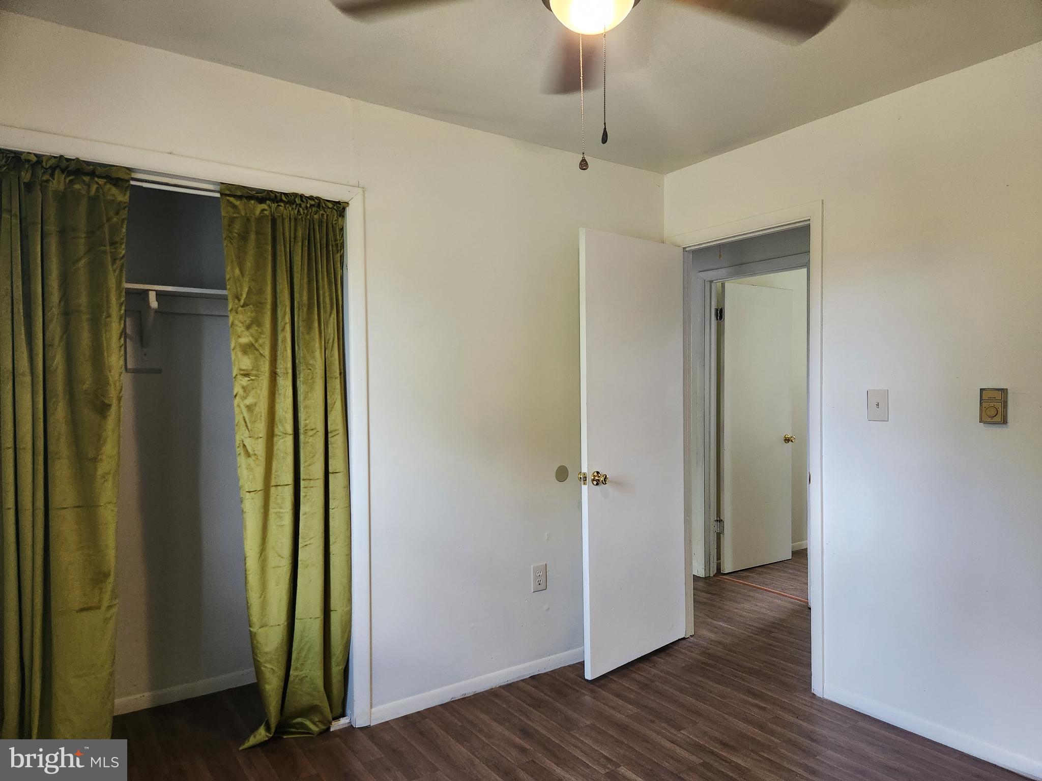 403 Rose Street Salisbury, MD 21801 - Photo 22 of 35 an empty room with wooden floor closet and chandelier