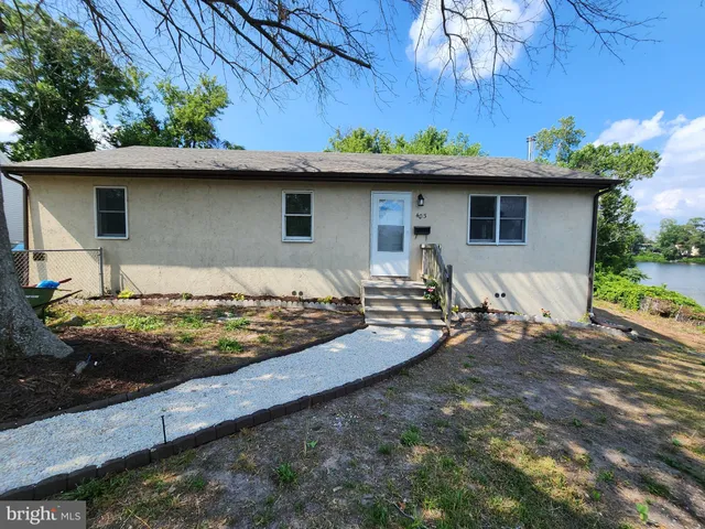 a view of a wooden house with a yard