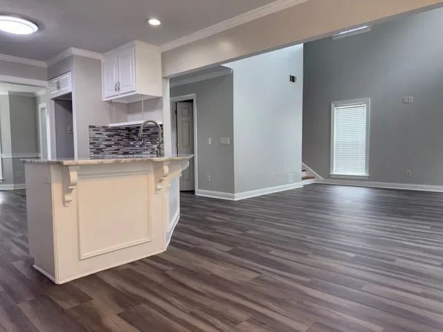 a view of kitchen and wooden floor