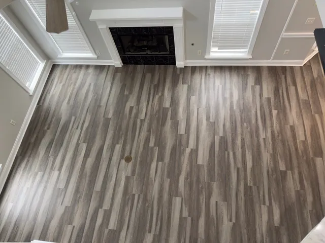 a view of a room with wooden floor