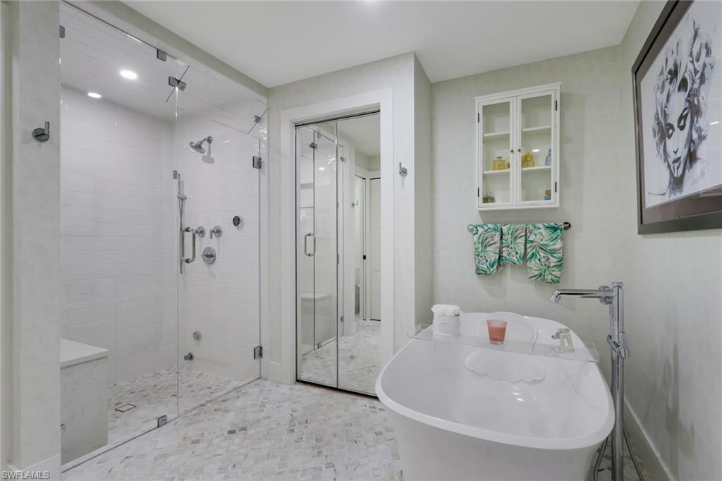 695 Regatta Road Naples, FL 34103 - Photo 16 of 43 Bathroom featuring a freestanding tub and a stall shower