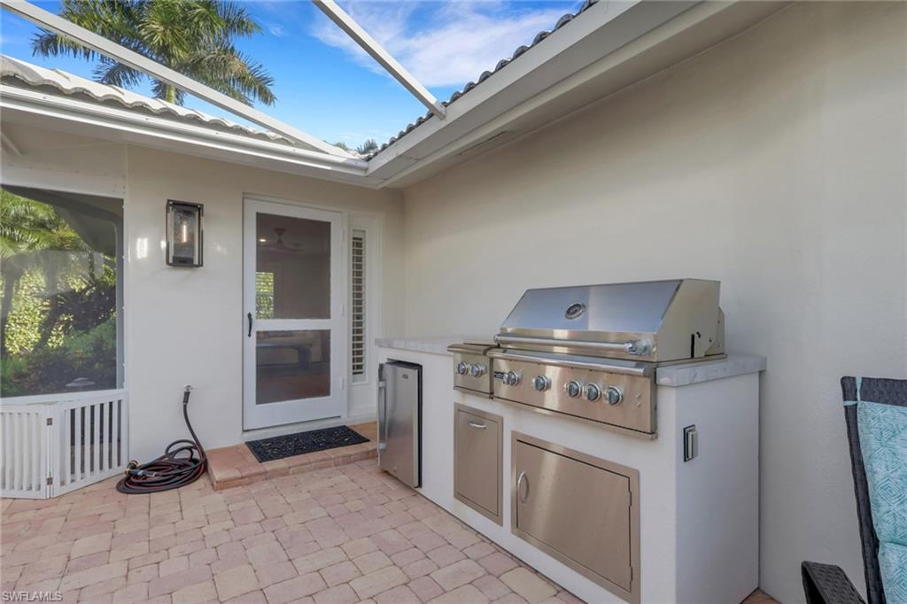 695 Regatta Road Naples, FL 34103 - Photo 17 of 43 View of patio featuring exterior kitchen