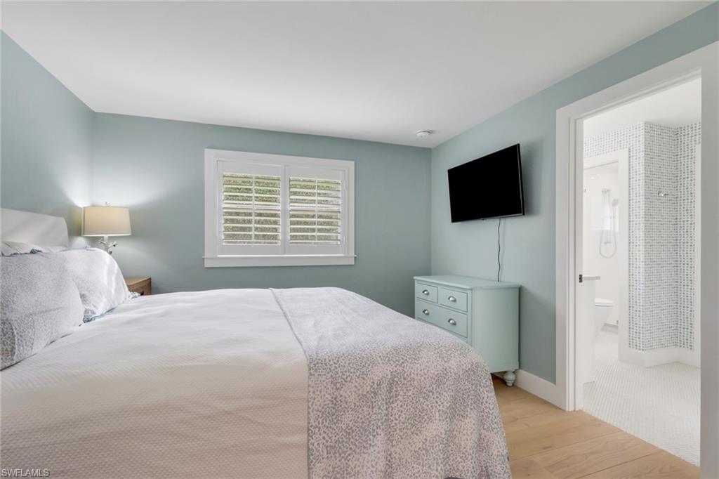 695 Regatta Road Naples, FL 34103 - Photo 24 of 43 Bedroom with light wood-style flooring and baseboards