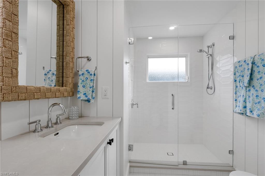 695 Regatta Road Naples, FL 34103 - Photo 28 of 43 Bathroom featuring vanity, a shower stall, and recessed lighting