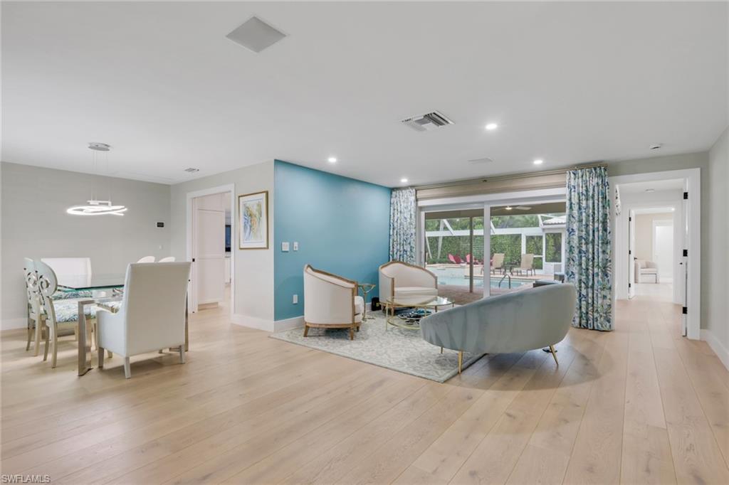 695 Regatta Road Naples, FL 34103 - Photo 5 of 43 Living area with light wood-type flooring, recessed lighting, and a chandelier