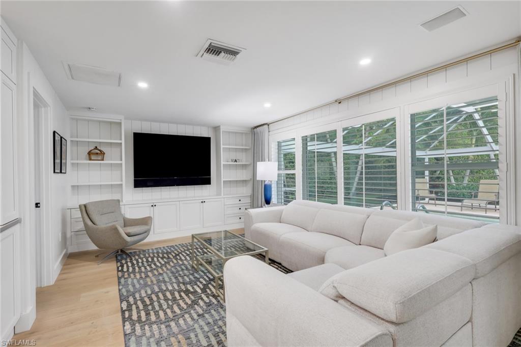695 Regatta Road Naples, FL 34103 - Photo 9 of 43 Living area featuring light wood-type flooring, built in shelves, and recessed lighting