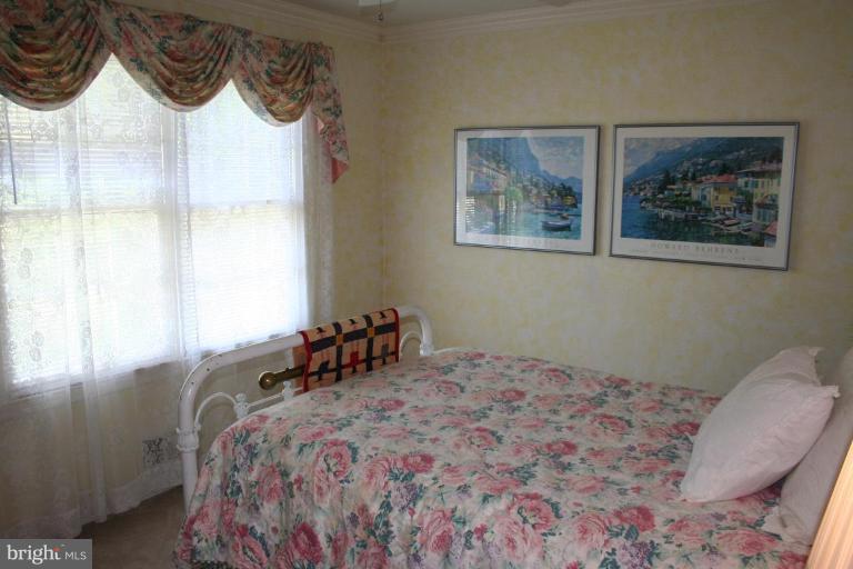 13703 Harcum Road Phoenix, MD 21131 - Photo 11 of 20 a bedroom with a bed and a painting on the wall