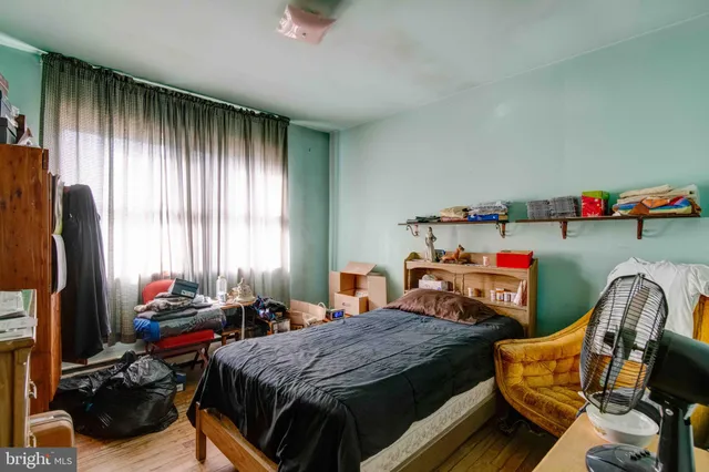 a bedroom with furniture and a flat screen tv