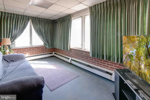 a view of room with window and furniture