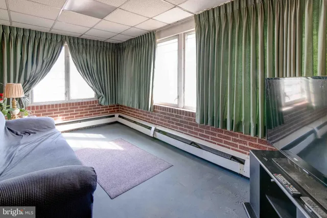 a view of room with window and furniture