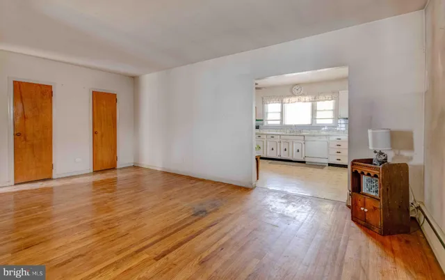 a view of a livingroom with wooden floor and a window