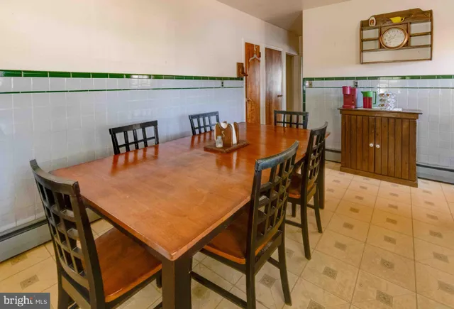a dining room with furniture and wooden floor