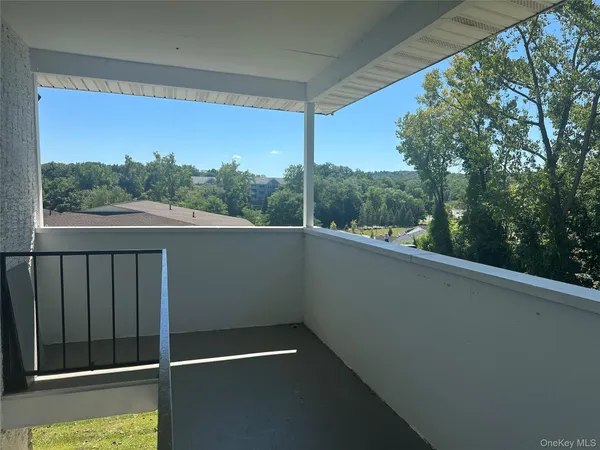 a view of a patio with table and chairs with wooden fence and floor